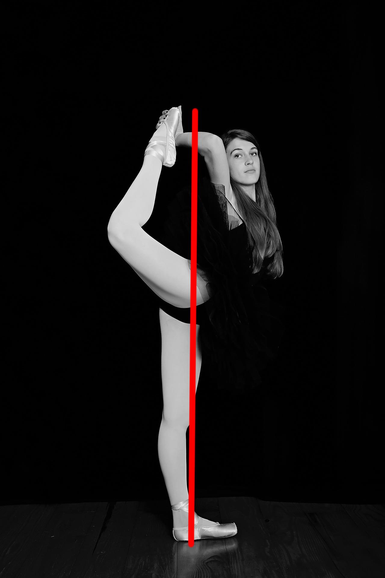 Dancer holding her leg behind her head. Red line demonstrates line of balance.