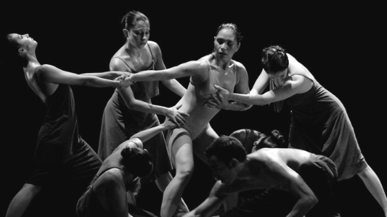 six modern dancers performing contact improvisation